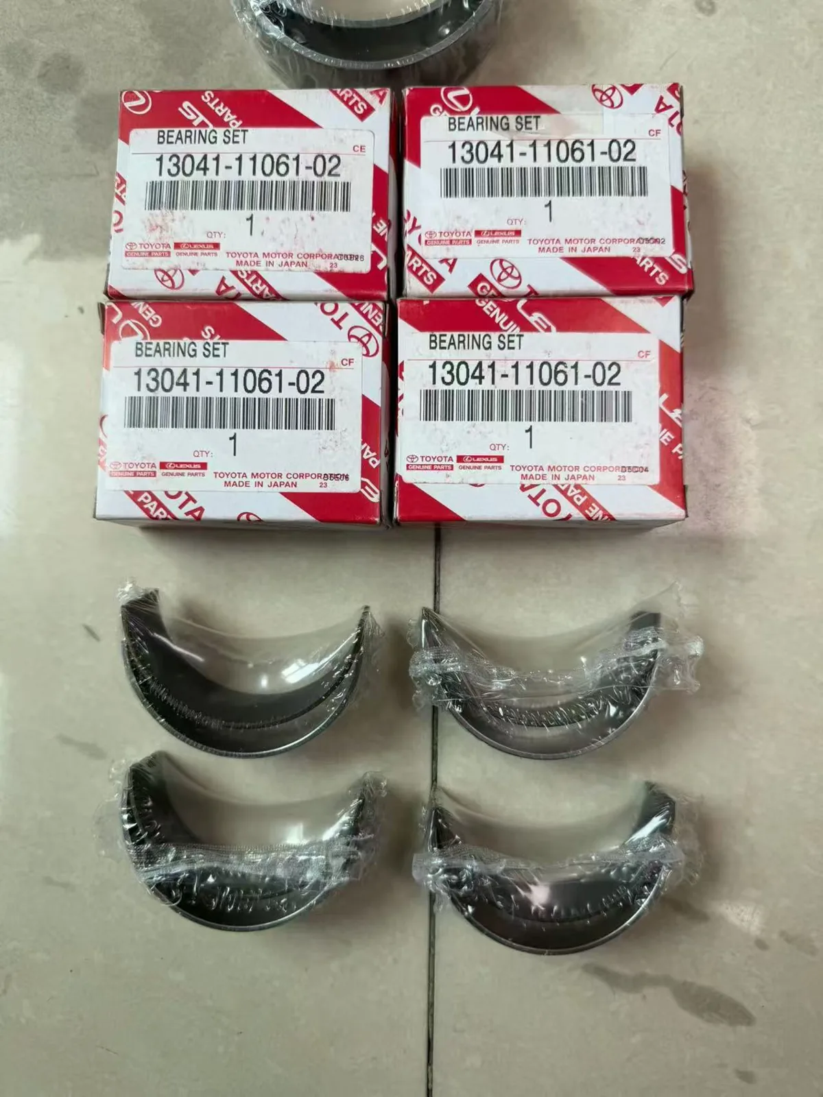 Bearing set parts and Toyota Lexus branded boxes labeled 13041-11061-02