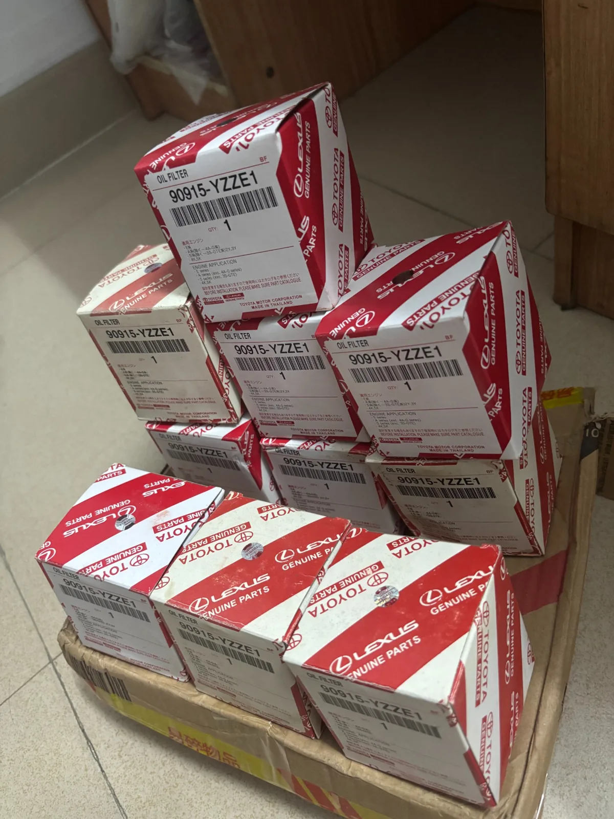 Stack of Toyota Lexus branded oil filter boxes labeled 90915-YZZE1